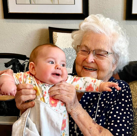 Great grandma holding her great granddaughter