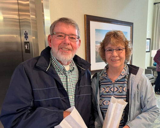 A couple at the grand opening snacking on pop corn