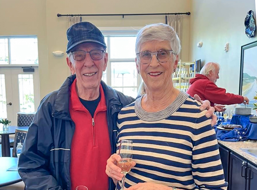 Couple at the grand opening drinking wine