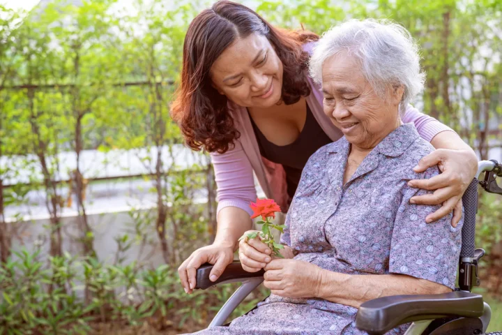 Adult daughter caring for her mother with dementia